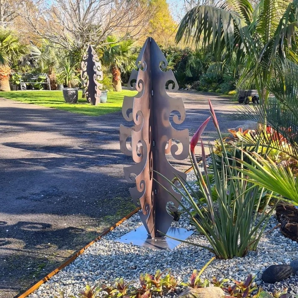 Tall Surf Symphony corten sculpture casting artistic shadows in evening garden light