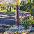 Tall Surf Symphony corten sculpture casting artistic shadows in evening garden light